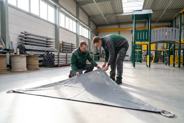 Shade sail fabric laid out for inspection