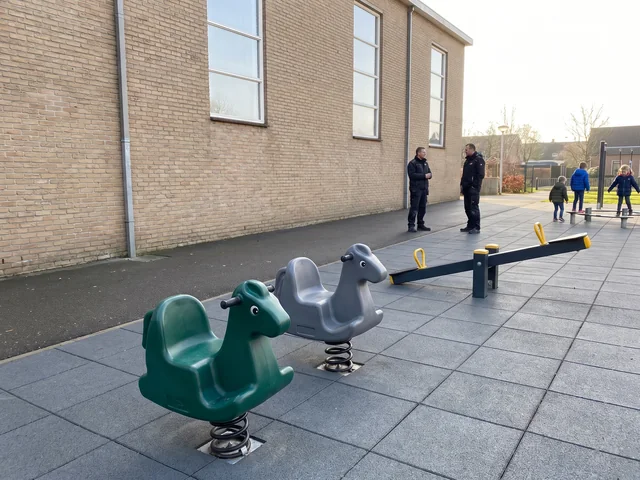 Two spring riders and a seesaw on rubber surfacing