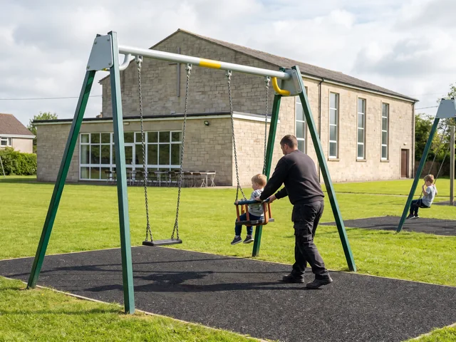 Two-bay swing frame with belt seats and a toddler bucket seat