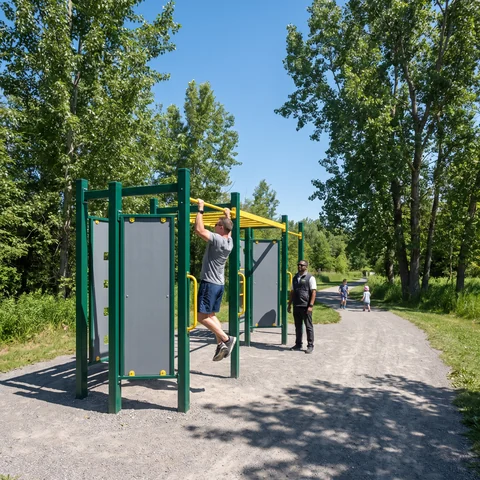 Outdoor fitness stations beside a park path