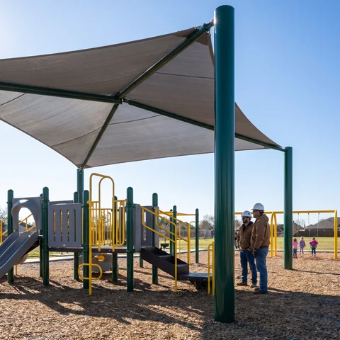 Shade sail over a playground on steel posts