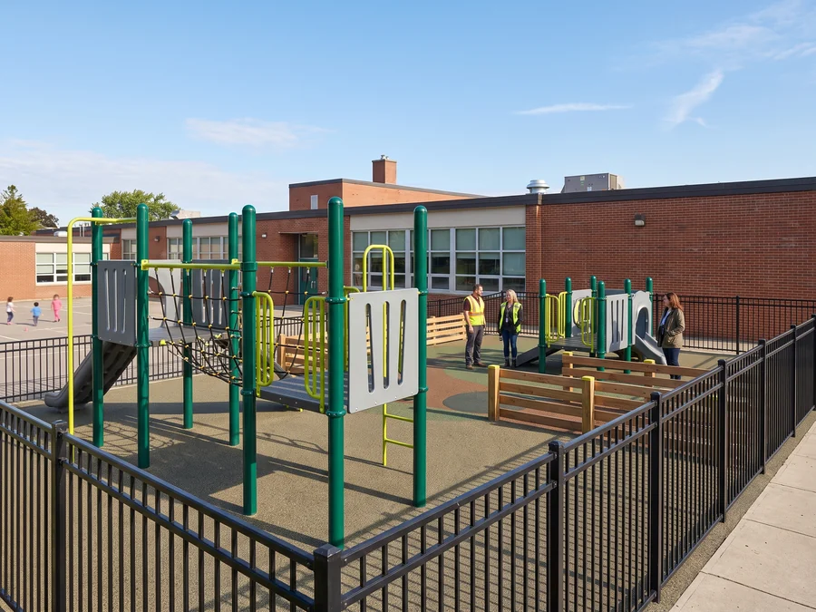 School playground zoned by age group next to a school building