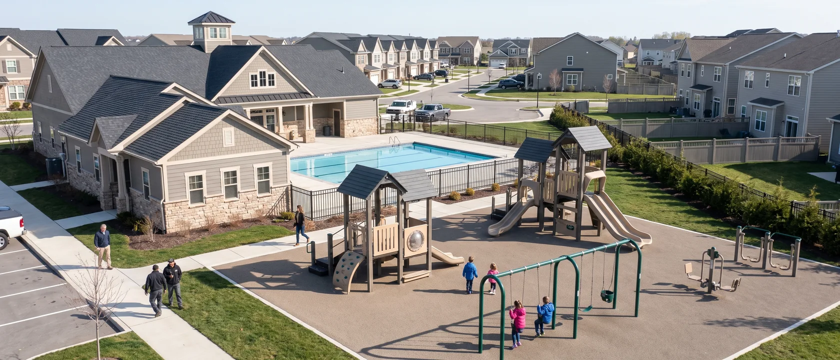 High view of a master-planned community's amenity area: clubhouse, pool and the main play area in the clubhouse colors