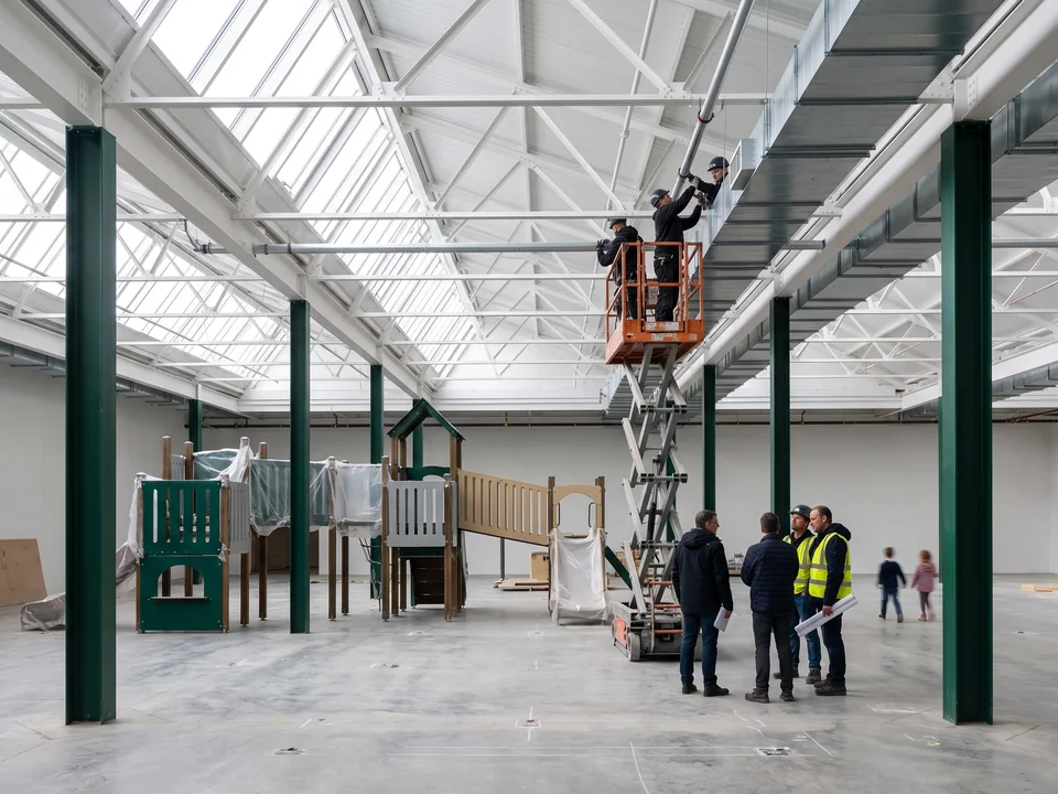 Contractors installing sprinklers and air ducts in the FEC building during production