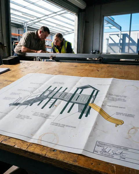 A printed approved playground drawing with a signed approval box