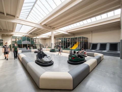 Electric bumper cars and a kiddie ride on an indoor floor