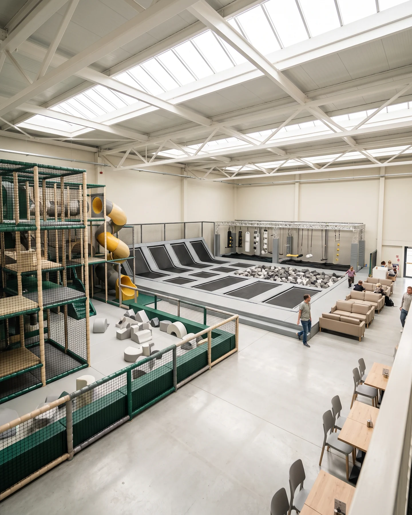 Family entertainment center floor with soft play, trampoline court and parent seating