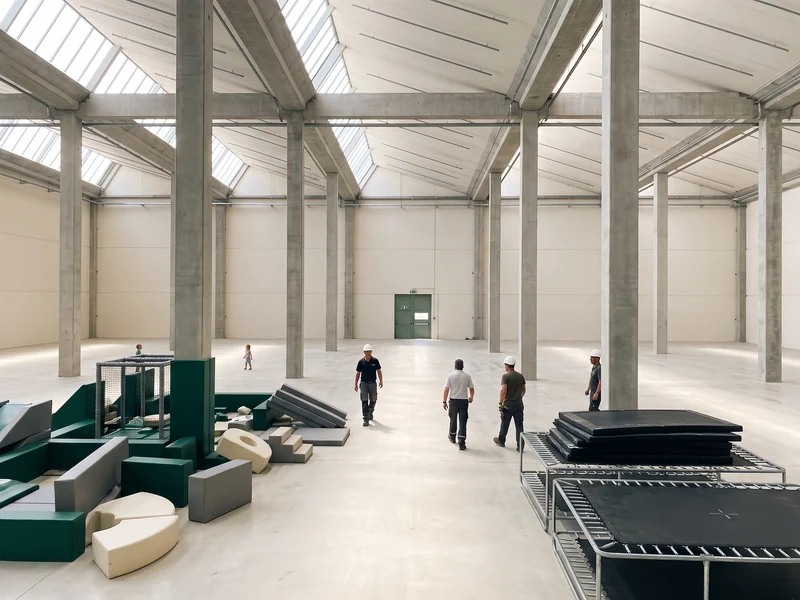 Empty leased building with columns, skylights and a fire exit door