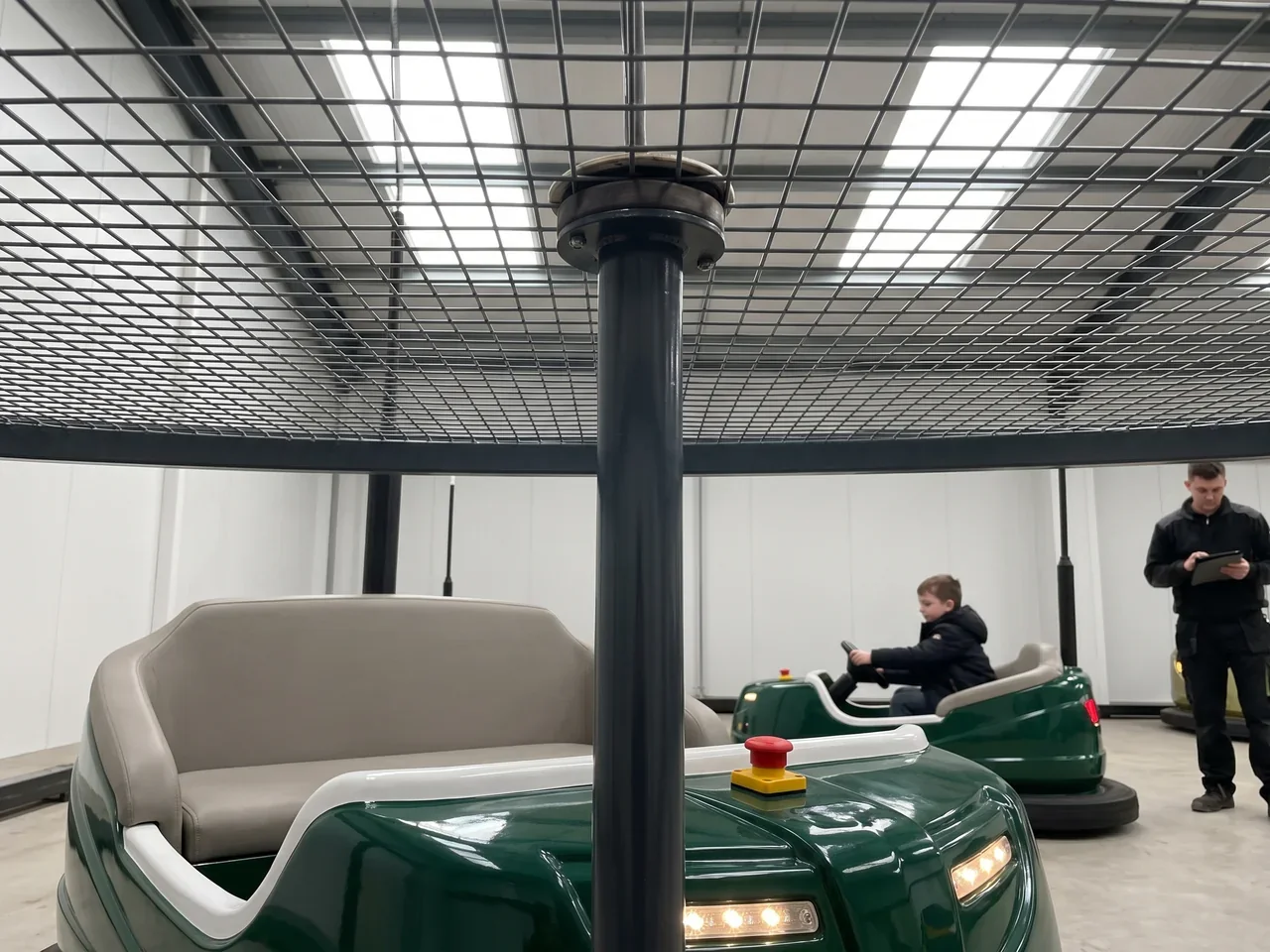 Bumper car pole touching a steel ceiling net