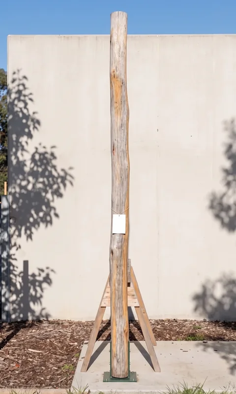 Timber piece L1-008, a deck bearer, photographed with its part tag before loading