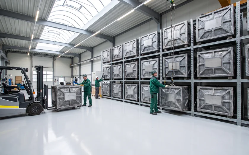 Steel molds stored on racks in the rotomolding workshop
