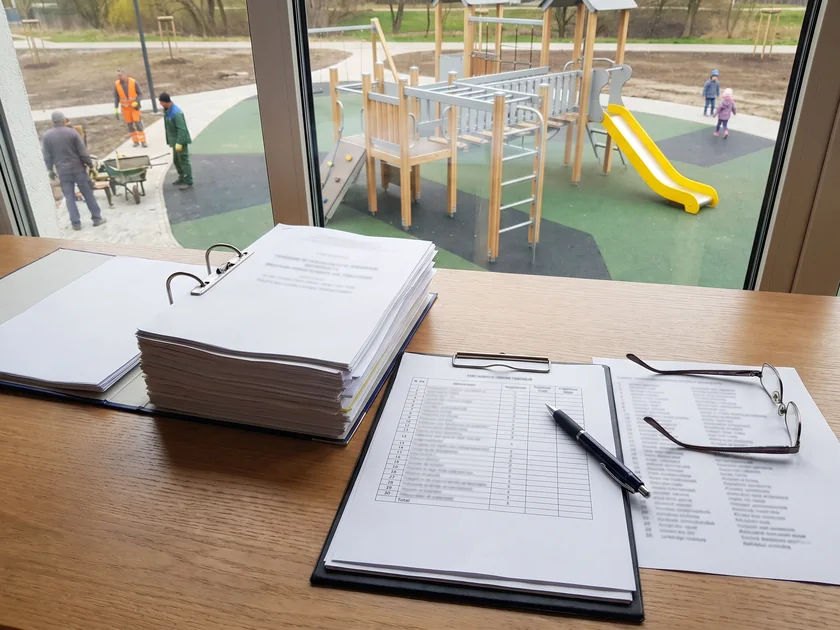 Tender documents with a surfacing area table clipped beside the equipment list