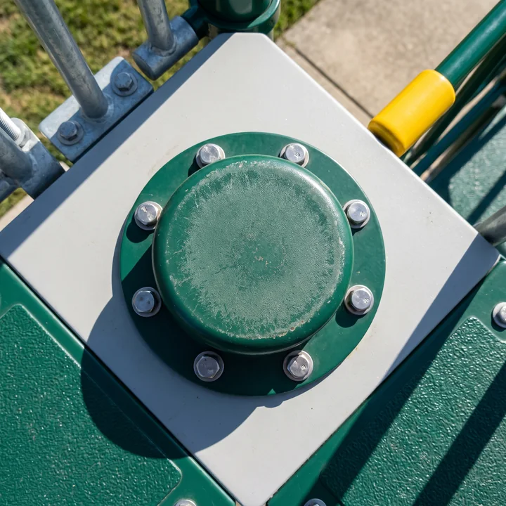 Top-down close-up of a spinner center cap ringed by capped tamper-resistant bolts