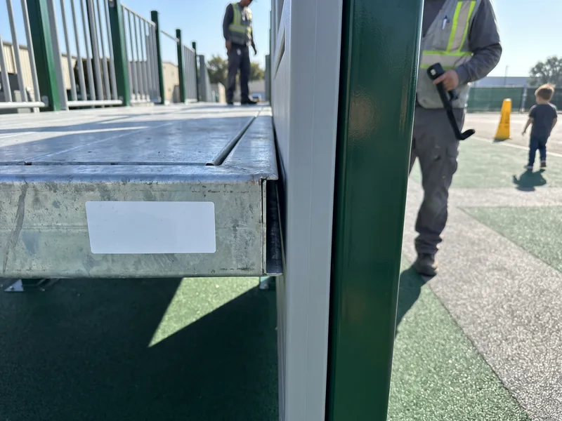 The gap between a deck edge and a barrier panel on a pre-assembled structure