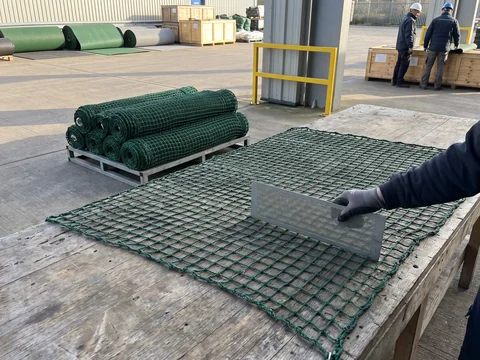 A mesh gauge held against knotless netting at incoming inspection