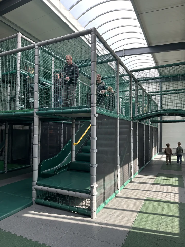 A corner of a multi-level soft play structure with EVA-wrapped clamps and knotless netting
