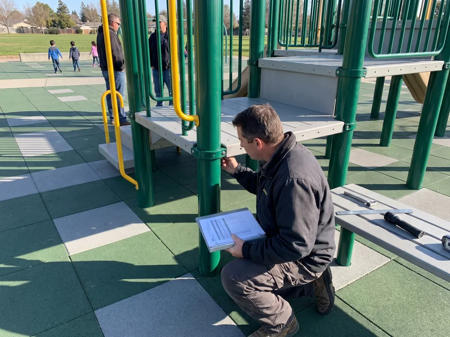 A site inspector checks a structure with a bound inspection guide
