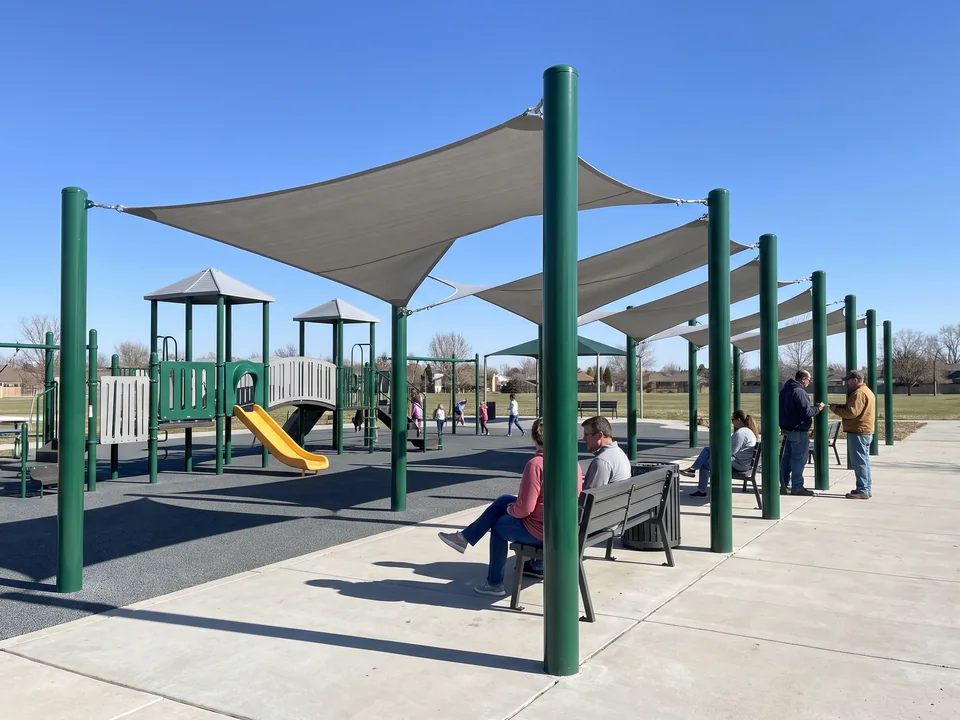 Multi-span canopy bays sharing posts along a seating edge and path