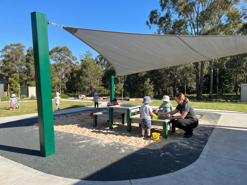 Cantilever shade over the sand and water play tables at a daycare