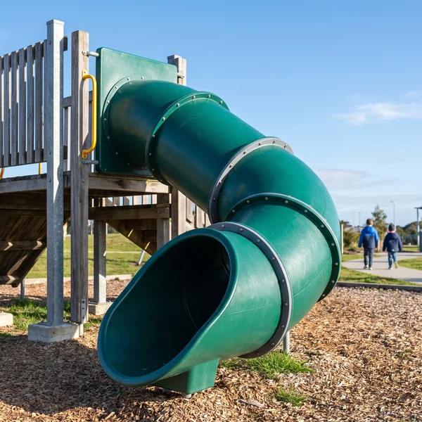 An evergreen tube slide with a bend section and visible flanged joints