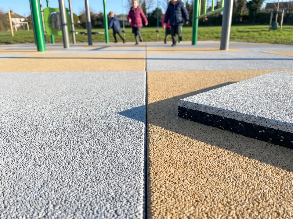 Close view of the joint between two rubber tiles with the granular wear layer visible