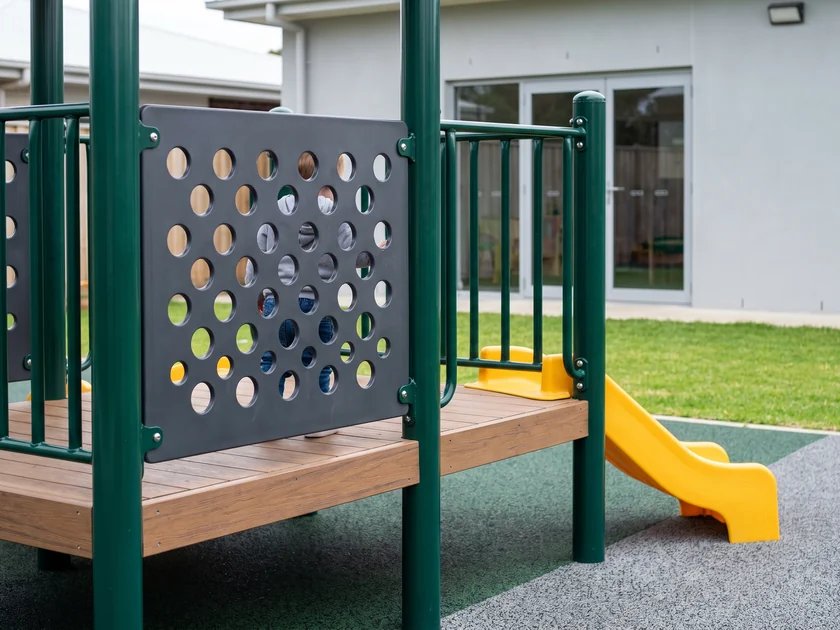 Perforated HDPE panel on a guardrail, the deck visible through it