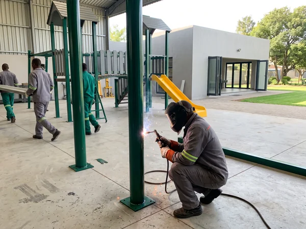 Welding a steel post in the steel workshop