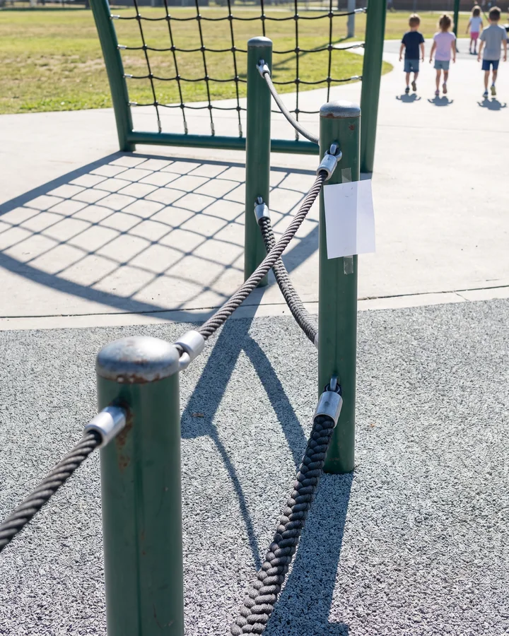 A low rope walk at ground level between short posts in a 2 to 5 play zone