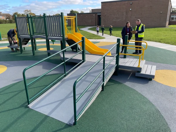 Transfer platform and ramp on an inclusive play structure