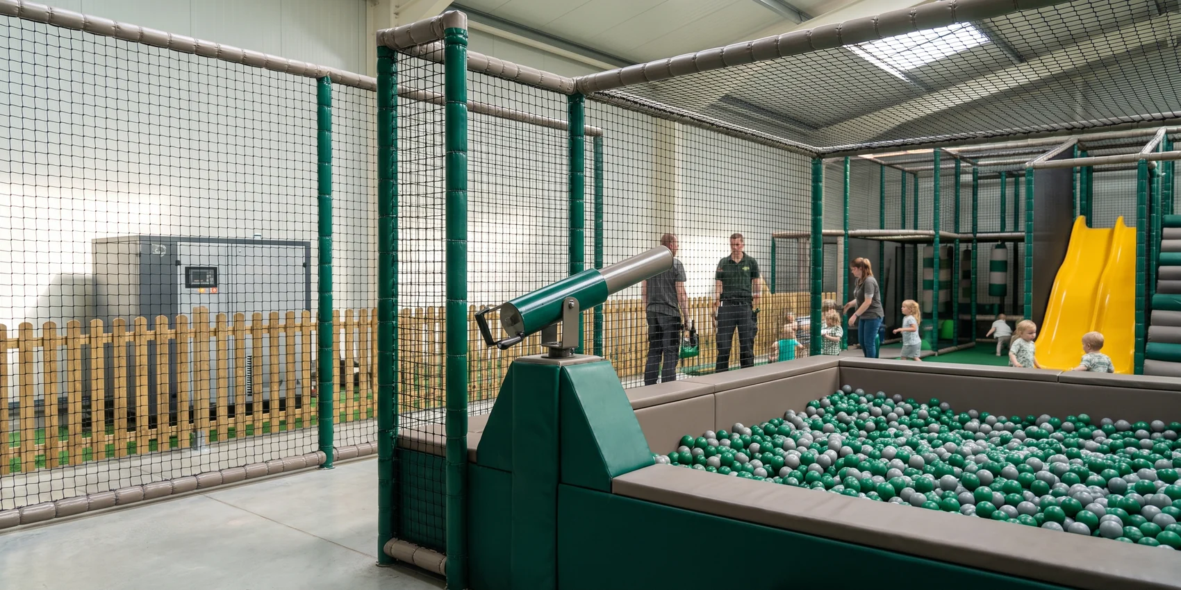 Ball blaster aimed across the ball pit, compressor outside the play area