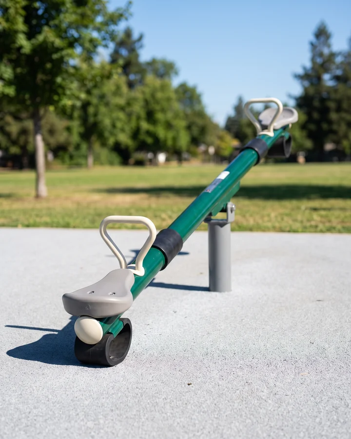 A classic beam seesaw with two seats and rubber bumpers under each seat end