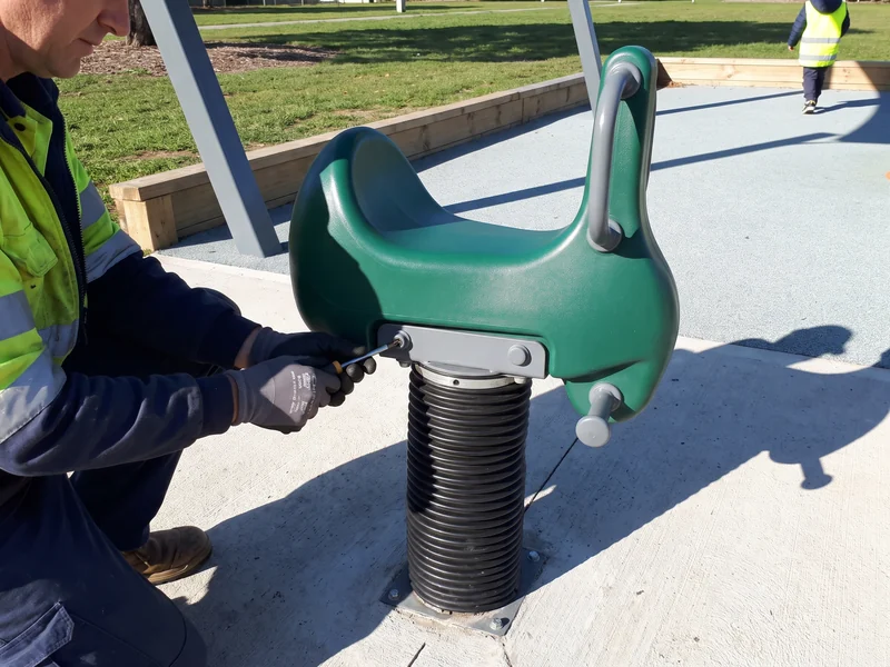A crew member unbolting a part while everything below stays in place