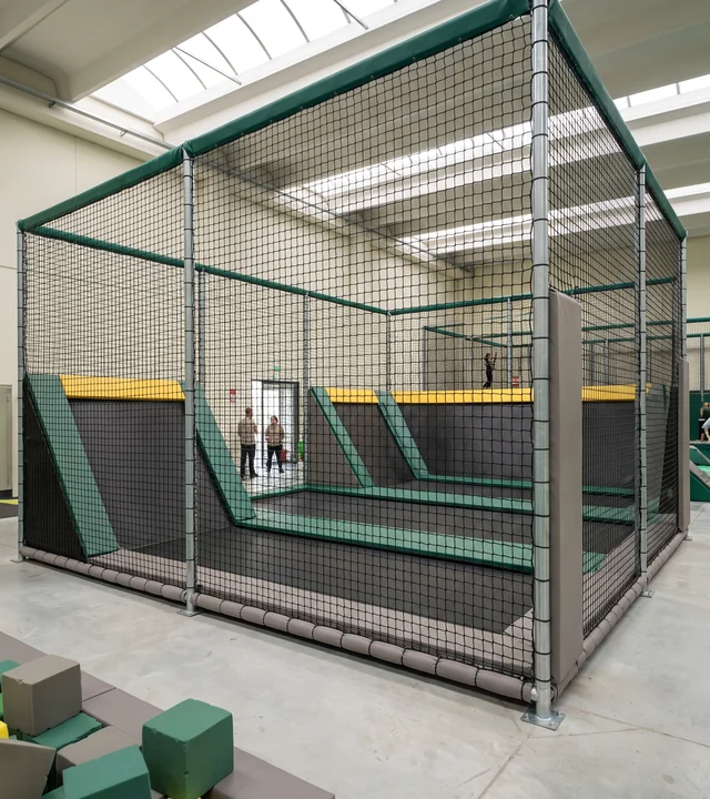Dodgeball court enclosed by black knotless netting
