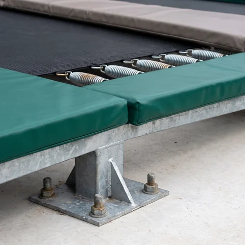Anchor bolt fixing a court frame foot to the slab