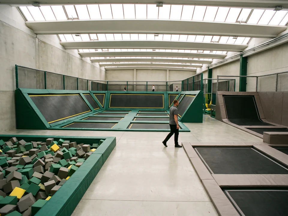Two courts padded in different colors, evergreen for dodgeball and warm grey for kids